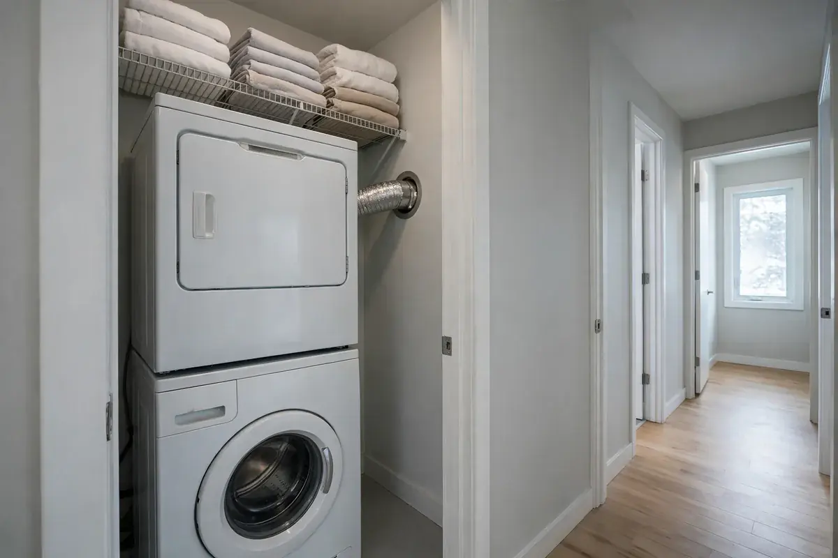 Laundry closet with a dryer, washer and short duct against the wall